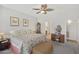 Bright main bedroom features a ceiling fan and a view into the main bathroom at 3089 E Hazeltine Way, Chandler, AZ 85249