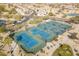 Aerial view shows well-maintained community tennis courts, surrounded by green spaces and scenic views at 3089 E Hazeltine Way, Chandler, AZ 85249