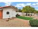 Charming backyard featuring a cozy shed, lush greenery, mature trees, and a lovely brick pathway at 3522 E Fountain St, Mesa, AZ 85213