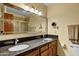 Primary bathroom featuring double vanity, light sconces, and a large mirror at 3522 E Fountain St, Mesa, AZ 85213