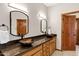 Bathroom featuring double sinks with vessel bowls, granite counters and dark wood cabinets at 3522 E Fountain St, Mesa, AZ 85213