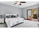 Serene bedroom with white bedding, ceiling fan and sliding glass doors to the patio at 3522 E Fountain St, Mesa, AZ 85213