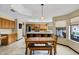 Bright dining area with a kitchen island, an adjacent kitchen, and a cozy dining set at 3522 E Fountain St, Mesa, AZ 85213