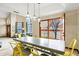 Dining area with bright yellow chairs and view through the glass door at 3522 E Fountain St, Mesa, AZ 85213