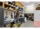 Functional garage space with ample shelving, storage cabinets, workbench, and lighting for various projects at 3522 E Fountain St, Mesa, AZ 85213