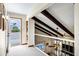 Hallway with exposed dark wood beams and black wrought iron banister at 3522 E Fountain St, Mesa, AZ 85213