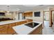 Spacious kitchen featuring a white island cooktop, custom cabinetry, and sleek appliances at 3522 E Fountain St, Mesa, AZ 85213