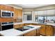 Bright kitchen featuring white countertops, ample cabinets, and a convenient cooktop island at 3522 E Fountain St, Mesa, AZ 85213