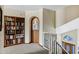 Upstairs landing with a built-in bookcase, and staircase with wrought iron railing at 3522 E Fountain St, Mesa, AZ 85213