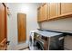 Laundry room with upper cabinets and front loading washer and dryer at 3522 E Fountain St, Mesa, AZ 85213