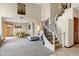 Elegant living space with a curved staircase and adjacent dining area, creating an open and airy atmosphere at 3522 E Fountain St, Mesa, AZ 85213