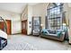 Bright living room with vaulted ceiling, large windows, and comfortable sofa and armchair at 3522 E Fountain St, Mesa, AZ 85213