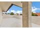 Covered stucco patio with exposed rafter tails overlooking neighborhood rooftops at 3522 E Fountain St, Mesa, AZ 85213