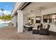 Covered patio area with comfortable seating, ceiling fans, and views of the pool at 3522 E Fountain St, Mesa, AZ 85213