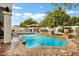 Beautiful backyard pool with a covered outdoor cooking area and mature citrus trees at 3522 E Fountain St, Mesa, AZ 85213