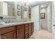 Modern bathroom with dual sink vanity, decorative mirrors, and separate toilet room at 36600 N Cave Creek Rd # C17, Cave Creek, AZ 85331