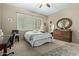 Relaxing bedroom features wooden dresser, large mirror, ceiling fan, and plantation shutters at 36600 N Cave Creek Rd # C17, Cave Creek, AZ 85331