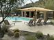 Community pool with hot tub and covered seating area, perfect for relaxation at 36600 N Cave Creek Rd # C17, Cave Creek, AZ 85331