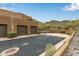 Exterior showcasing a desert home with stone accents, ample parking, and beautiful mountain views at 36600 N Cave Creek Rd # C17, Cave Creek, AZ 85331