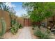 Landscaped pathway with native plants leads to a private gate, enhancing curb appeal at 36600 N Cave Creek Rd # C17, Cave Creek, AZ 85331