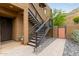 Exterior stairs accessing an upper unit, complemented by desert landscaping and secure gated entry at 36600 N Cave Creek Rd # C17, Cave Creek, AZ 85331