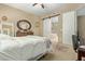 Comfortable bedroom features neutral color scheme and en suite bathroom with separate tub and shower at 36600 N Cave Creek Rd # C17, Cave Creek, AZ 85331