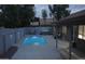 A backyard featuring a refreshing pool, hot tub, patio, and privacy wall, perfect for outdoor relaxation and entertainment at 372 W Larona Ln, Tempe, AZ 85284