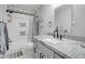 Stylish bathroom featuring modern fixtures, elegant vanity, and a shower-tub combo with decorative tile at 372 W Larona Ln, Tempe, AZ 85284