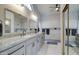 Bathroom featuring dual sinks, walk-in shower, and white marble throughout at 372 W Larona Ln, Tempe, AZ 85284