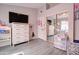 Spacious bedroom featuring mirrored closet, tv, dresser, and natural light at 372 W Larona Ln, Tempe, AZ 85284