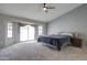 Bright bedroom with ceiling fan, carpet, large slider door and windows at 372 W Larona Ln, Tempe, AZ 85284