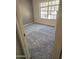 Bright bedroom featuring a large window for ample natural light and neutral carpeting at 372 W Larona Ln, Tempe, AZ 85284