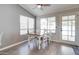 Dining room features modern lighting, white wood table, four chairs and hardwood floors at 372 W Larona Ln, Tempe, AZ 85284