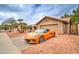 Single story home with desert landscaping, tile roof, and an attached two-car garage at 372 W Larona Ln, Tempe, AZ 85284