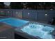 A rejuvenating hot tub next to the pool, with built-in lights, perfect for relaxation and unwinding in your backyard at 372 W Larona Ln, Tempe, AZ 85284