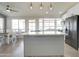 Kitchen features center island with marble countertop, stainless appliances and wood floors at 372 W Larona Ln, Tempe, AZ 85284