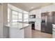 Modern kitchen with white countertops, cabinetry, stainless steel appliances and hardwood floors at 372 W Larona Ln, Tempe, AZ 85284