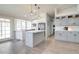 Spacious kitchen with center island, gray cabinets, stainless steel appliances, and modern pendant lighting at 372 W Larona Ln, Tempe, AZ 85284