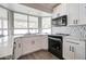 Renovated kitchen features white cabinetry, stainless appliances and marble countertops at 372 W Larona Ln, Tempe, AZ 85284