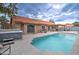 Lush backyard showcasing a refreshing pool, a soothing hot tub, and comfortable outdoor seating under cloudy skies at 372 W Larona Ln, Tempe, AZ 85284