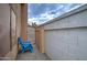 Private side yard with decorative gravel, an access gate, and a colorful chair at 372 W Larona Ln, Tempe, AZ 85284