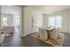 This dining room features a modern chandelier, a wooden table with seating, and a decorative rug over stylish flooring at 3901 S Adobe Dr, Chandler, AZ 85286