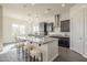 This kitchen features dark cabinets, granite countertops, a stylish island, a breakfast bar, and stainless steel appliances at 3901 S Adobe Dr, Chandler, AZ 85286