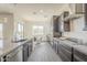 This kitchen features dark cabinets, granite countertops, stainless steel appliances, and a breakfast bar with seating at 3901 S Adobe Dr, Chandler, AZ 85286