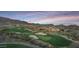 A picturesque golf course and clubhouse, all surrounded by scenic mountain views at 40614 N Harbour Town Ct, Anthem, AZ 85086