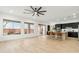 Open concept living area with hardwood floors, modern ceiling fan, and a view to the kitchen at 40614 N Harbour Town Ct, Anthem, AZ 85086