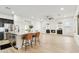 Open concept living space showcasing the kitchen island, fireplace with built-ins, and light wood floors at 40614 N Harbour Town Ct, Anthem, AZ 85086