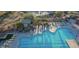 Aerial view of a community pool with shaded lounge areas and well-maintained facilities at 40614 N Harbour Town Ct, Anthem, AZ 85086