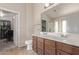 Bathroom featuring double sinks, vanity and a walk-in closet for optimal storage at 41838 W Anne Ln, Maricopa, AZ 85138