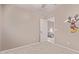 Neutral bedroom featuring an open door and a playful Mickey Mouse wall decal at 41838 W Anne Ln, Maricopa, AZ 85138